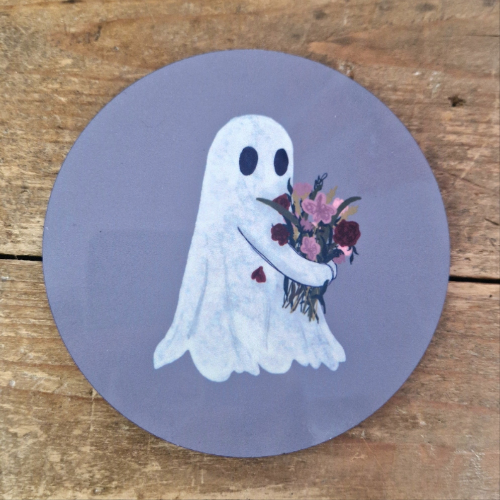 The Flower Ghost Coaster by Duck Egg Designs features a cartoon flower ghost with a bouquet and red heart, set against a purple background, perfect for adding charm to any wooden surface.