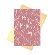 Load image into Gallery viewer, A rich pink card sits on a brown paper envelope in front of a white background. The card has the words ‘Happy Mothers Day’ in white with a white heart to the broom left of it. A leafy vine design grows in towards the words from the edge of the card.
