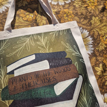Load image into Gallery viewer, A close up view of the top of the bag showing the book stack design in greater detail. Behind the white bag you can see a warm brown retro floral patterned background.
