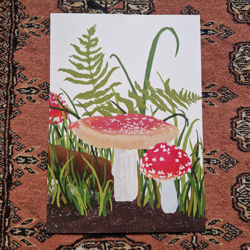 A view of the full print on a textured red patterned background. The print is white with fly agaric fungi growing from the bottom of the print along with ferns and green grasses. Across the bottom of the print you can see a brown soil. 