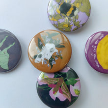 Load image into Gallery viewer, A group of five badges lay on a white background. From L to R, top to bottom you can see a lilac badge with a bumblebee and honeysuckle above a lilac grey badge with a pastel green luna moth, a mustard brown badge with a dog skull and dogbane flowers and a pink badge with a yellow lemon and white writing. At the bottom of the group is a dark blue badge with pink evening primrose flowers behind a pink, green, black and white elephant hawk-moth.

