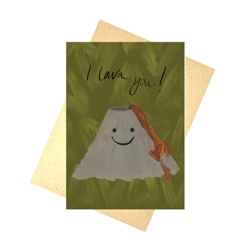 An olive green card with paler green heart outlines across in, featuring a grey volcano with red lava and a smilng face under the words 'I lava you!' in black handwriting. Behind the card is a recycled brown paper envelope, behind which is a white background.
