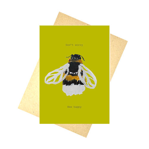 Warm yellow card featuring a hand drawn bee and the words 'Don't worry Bee happy'. Behind the card is a brown envelope, behind which is a white background.