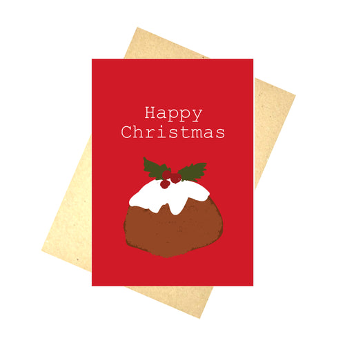 A red card featuring a simple christmas pudding illustration. Above the pudding are the words 'Happy Christmas' in contrasting white. Behind the card is a brown envelope, behind which is a white background.