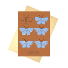 Load image into Gallery viewer, Common Blue Butterfly. A warm orange portrait card with six butterflies in rows of two. The butterflies are in the different stages of drawing showing the illustration going from just an outline to the full piece. At the bottom of the card is the english and latin names of the butterfly. Behind the card is a brown envelope, behind which is a white background.
