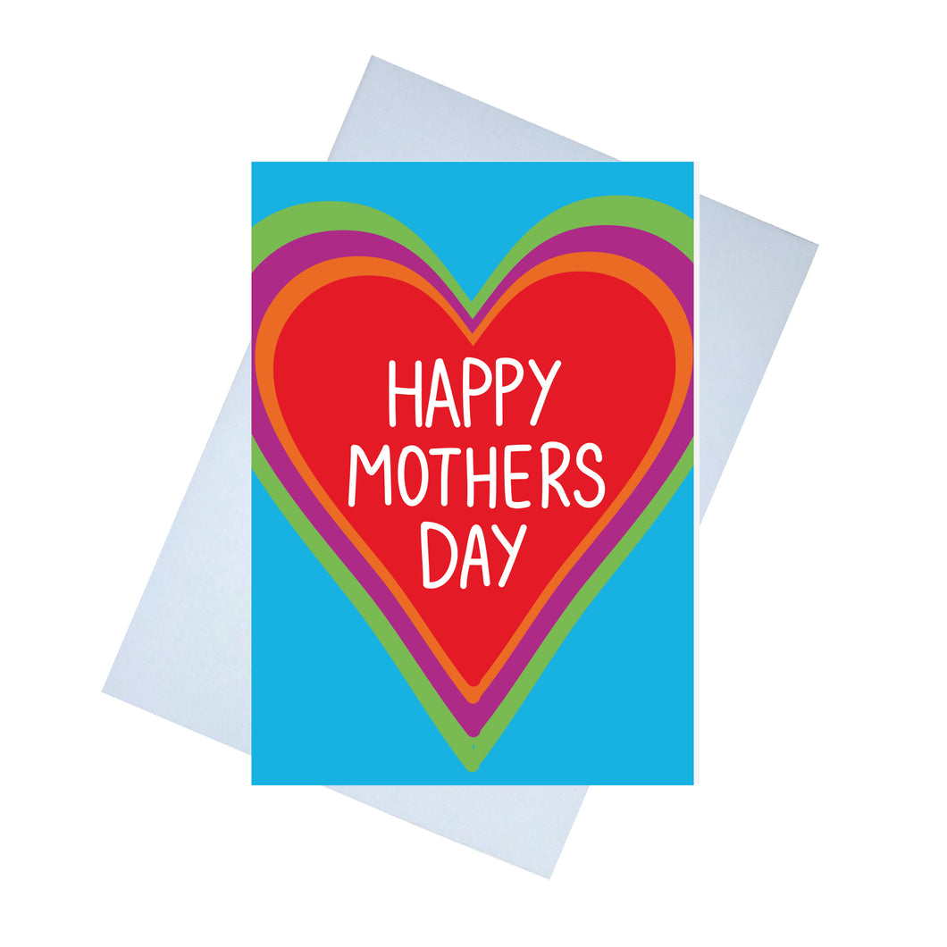 Blue card featuring a large red heart with the words 'HAPPY MOTHERS DAY' in white. Behind the red heart is an orange border in the shape of a heart, behind which is a purple and a green too. Behind the card is a lilac envelope behind which is a white background.
