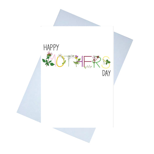 A white card with the words HAPPY MOTHERS DAY across it. HAPPY and DAY are in black, while MOTHER is in different colours, corresponding to the flowers with each letter. Behind the card is a lilac envelope, behind which is a white background.