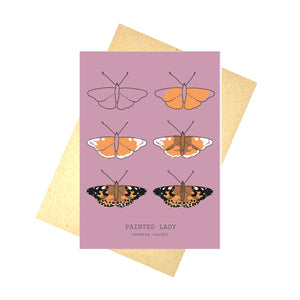 A warm pink card featuring the drawing stage for a pinted lady butterfly across six outlines. At the bottom of the card are the english and latin versions of the name written in black. Behind the card is a brown envelope, behind which is a white background.