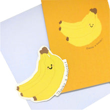 Load image into Gallery viewer, A yellow orange card with a cartoon banana and the words &#39;Thanks a bunch!!&#39; are to the top right of the pic. Behind the card but slightly further down is a lilac envelope, on top of which is a yellow banana sticker. Behind everything is a white background.
