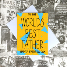 Load image into Gallery viewer, A warm yellow card with a light blue triangle and dot print. The words TO THE WORLDS BEST FATHER HAPPY FATHERS DAY are written in black centrally across the card. Behind the card is a lilac envelope, on top of a black and white collaged print background.
