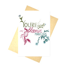 Load image into Gallery viewer, A white card sits on a brown envelope in front of a white background. The card has the words &#39;YOU&#39;RE bloomin MARVELOUS&#39; in different handwritten fonts and colours. Growing from the edges of the words are different flowers and plants that match the colour of the word - green for YOU&#39;RE, pink for bloomin and blue for MARVELOUS.
